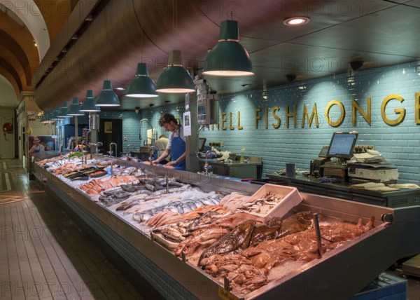 Cork, Ireland, 16 August, 2022: fishmonger market stall with fresh fish and seafood on ice inside the English Market in Cork, Europe
