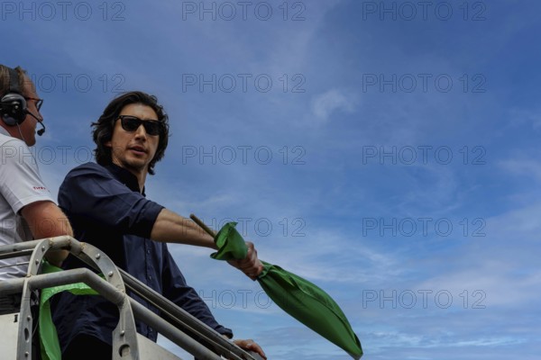 Honorary starter, Adam Driver, prepares to drop the green flag for the Indianapolis 500 in Indianapolis, IN, USA, North America