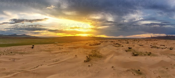 Aerial panorama view of the sand dunes Elsen Tasarhai (Bayan Gobi) desert at sunset in Mongolia