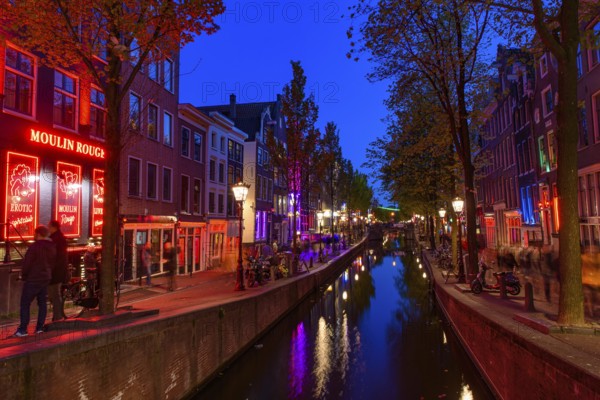 Night view of De Wallen, the famous red-light district with window prostitution in Amsterdam, Netherlands