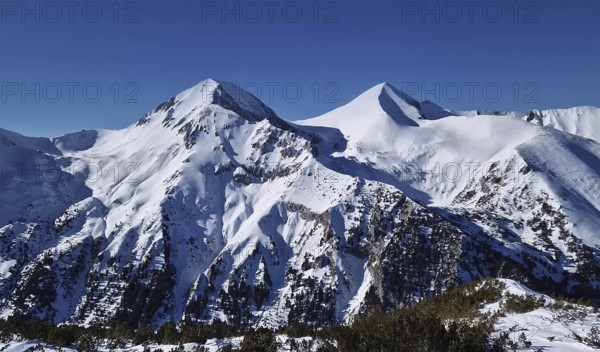 Beautiful Pirin mountains peaks covered with snow. Winter view at Bansko ski resort in Bulgaria