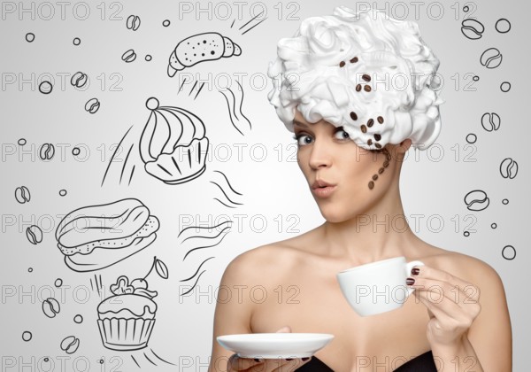 Young beautiful woman with whipped cream on her hair, with a curl of coffee beans, drinking coffee and holding a coffee cup, against a sketchy background of bakery sweets