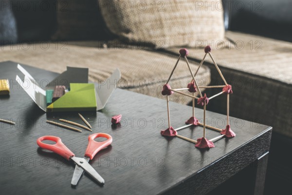 Make house with wooden sticks and plasticine