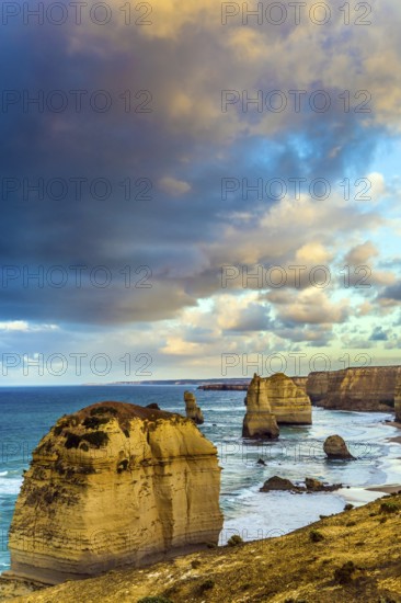 Travel to Australia. Pink dawn clouds over the rocks Twelve Apostles. Morning on the ocean shore. The concept of active, ecological and photo tourism