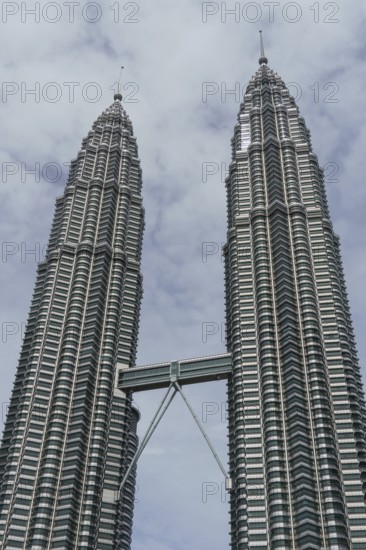 Two striking twin towers under a cloudy sky, modern and majestic, kuala lumpur, malaysia