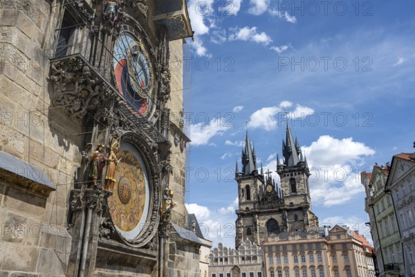The famous astronomical clock and the Teyn Church in Prague on a sunny day