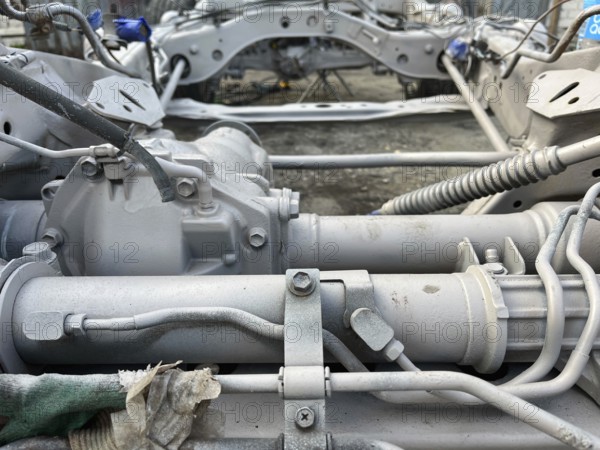 Detailed view of gearbox and mechanical parts of a vehicle in a workshop