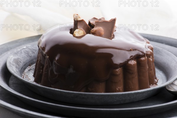 Chocolate pudding with chocolate dressing on a plate