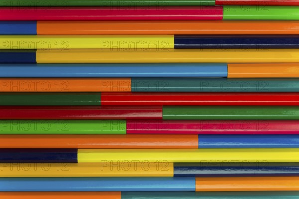 Collection of coloured pencils in a horizontal complementary colors set up as background picture