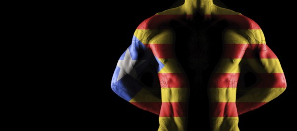 Catalonia flag on muscled male torso with abs, black background