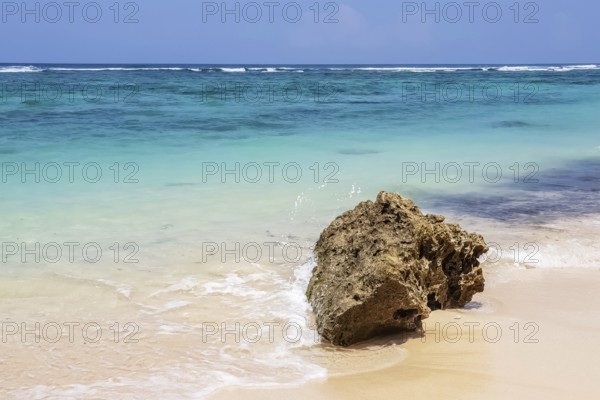 Day view on stone and Indian ocean and on Karma beach with white sand on Bali, Indonesia, Asia