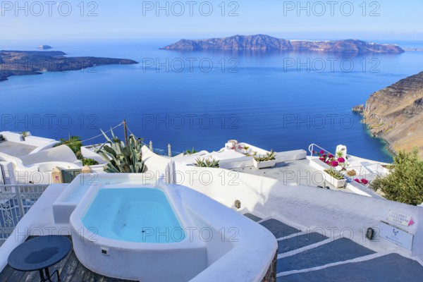 White buildings and hotels with panoramic view of Aegean Sea in Fira, Santorini, Greece, Europe