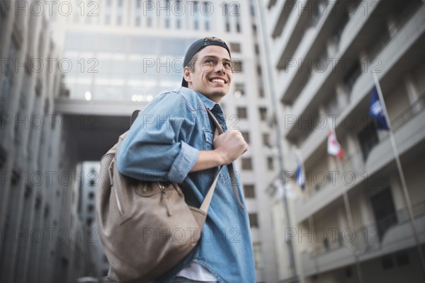 Background on the street while waiting his colleagues. Businessman wearing casual white shirt and spectacles. People