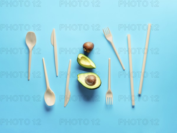 Avocado Seeds Biodegradable Single-Use Cutlery. Bioplastic - Great alternative to plastic disposable cutlery. Minimal concept on blue background