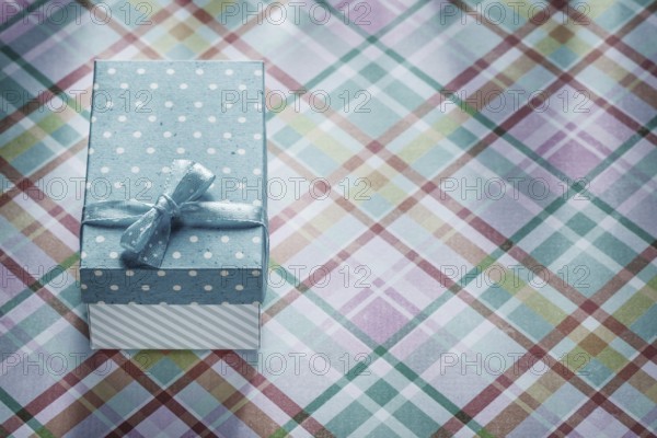 Gift box on checked fabric celebrations concept