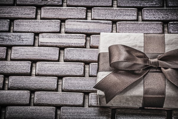 Present with ribbon on wooden mat horizontal view holidays concept