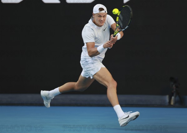 Danish tennis player Holger Rune playing a backhand shot at the Australian Open 2025 tournament, Melbourne Park, Melbourne, Victoria, Australia, Oceania