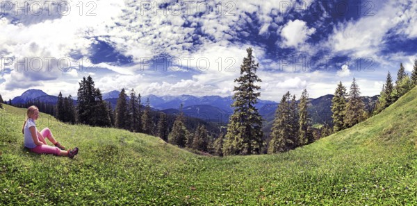 Girl in a meadow with the Blaubergalm, Tyrol, Austria Girl in a meadow with the Blaubergalm, Austria, Europe