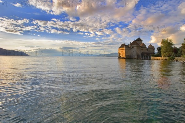 A medieval fortress ?hillon on lake Leman on a sunset