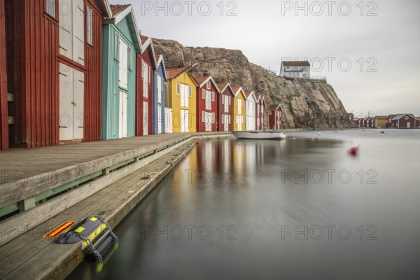 Small colourful houses by the sea. Typical houses in Sweden for the coastal landscape. Crab fishing and storage in a narrow harbour. Smögen, Smögenbryggan, Sweden, Europe
