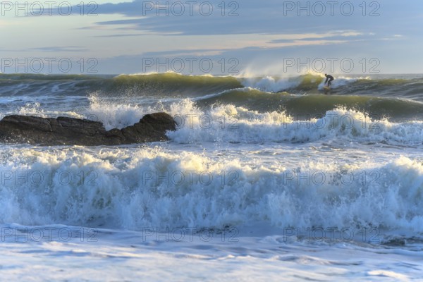 Surfer in action on the ocean waves on a sunny day in France