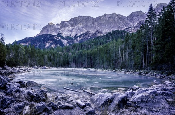 Winter scenery with an alpine frozen lake surrounded by the German Alps, near the municipality Grainau, district Garmisch-Partenkirchen, Bavaria, Germany, Europe