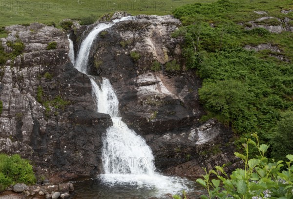 Water flowing in the beautiful waterfalls of the Meeting of the Three waters in the highlands of Scotland