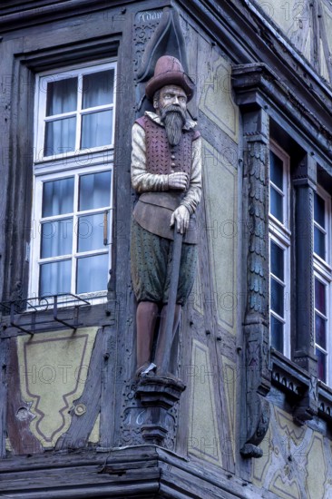 Detail of the famous historic half-timbered building from 1537 Haus Pfister (Maison Pfister) with a carved sculpture of a medieval man on the corner of the building, Colmar, Alsace, Département Bas-Rhin, France, Europe