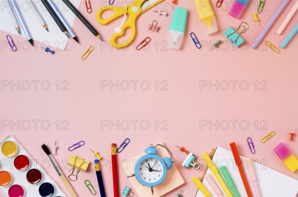 Creative student desk with school supplies and copy space in center. Top view or flat lay. Trendy back to school flat lay on pink background