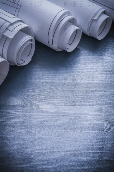 Verticla view five rolls of blueprints very close up