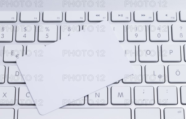 White keyboard with a blank white pastille card