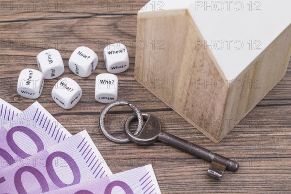 The photo shows a model house with various question cubes and a key