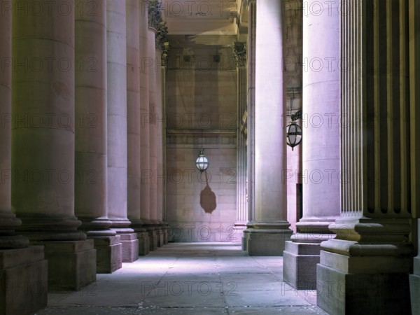 The entrance of the historic 19th century leeds city hall building illuminated at night