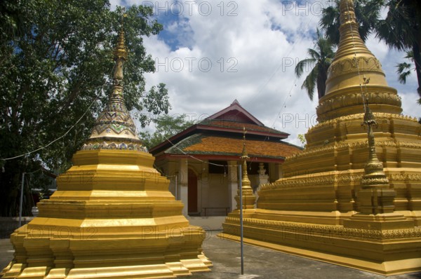 In the south-east corner of Chiang Mai's old city stands Wat Myanmar, a fine example of a 19th century Burmese temple which would not look out of place in Mandalay. This temple is mainly associated with the lowland Burman tradition in the city, and pictures of the Shwedagon Pagoda and Sule Pagoda in Yangon (Rangoon) adorn the walls