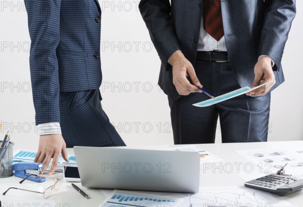 Business partnership concept with business people. Office desk with financial analytics. Business meeting in conference hall. Presentation and discussion of new startup project. Strategy development