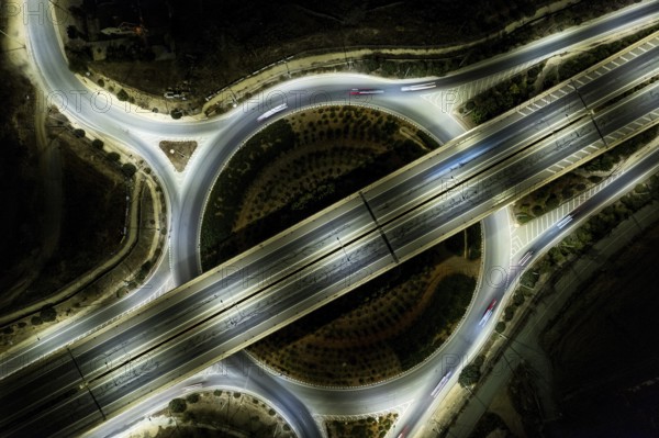 Aerial drone top view of a modern designed motorway junction. roundabout with cars moving. Cars moveing fast. Transportation infrastructure, Nicosia Cyprus
