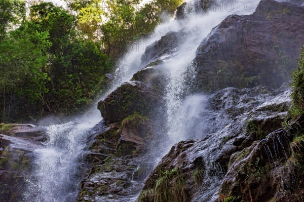 Water splashing through the rocks and forest forming a beautiful waterfall in Minas Gerais, Brazil, South America