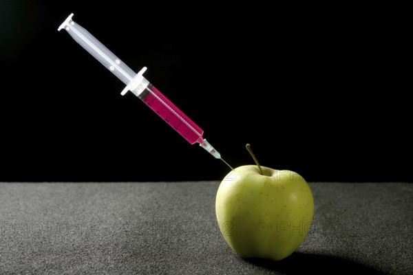 Bio genetics research of food, apple manipulation with syringe