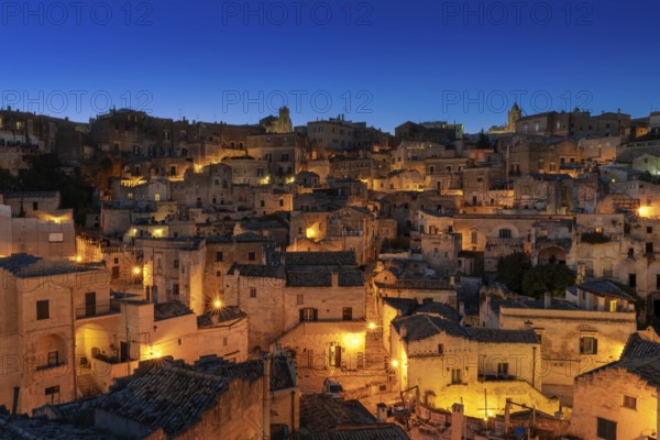 Matera, Italy, 26 November, 2023: view of the old town of Matera after sunset with the lights coming on, Europe