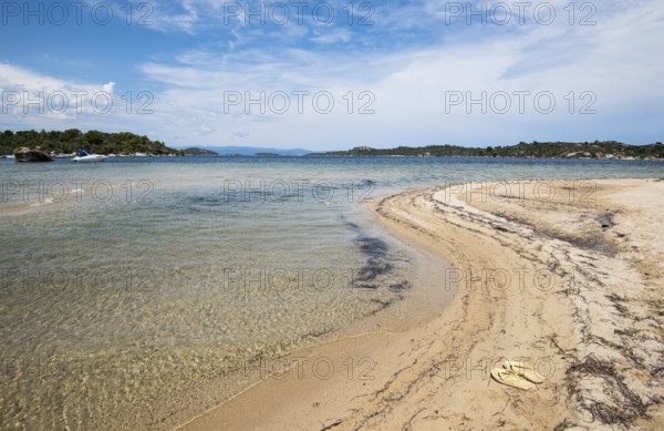 Idyllic tropical beach with gold sand and deep blue calm waters at Halkidiki, Greece. Concept of summer vacations
