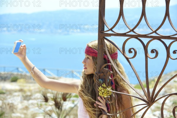 Blond girl selfie photo in mediterranean sea gate at Spain