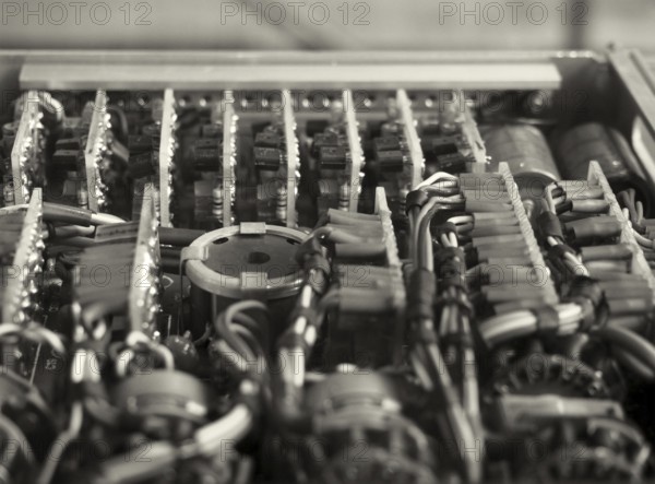 Monochrome selective focus image of complex colored wiring and connectors joining circuit boards with electrical components