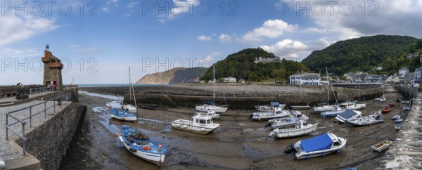 Lynton and Lynmouth, united Kingdom, 2 September, 2022: panorama view of the harbor and village of Lynmouth in North Devon with many boats stuck at low tide
