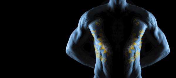 South Dakota flag on muscled male torso with abs, South Dakota bodybuilding concept, black background