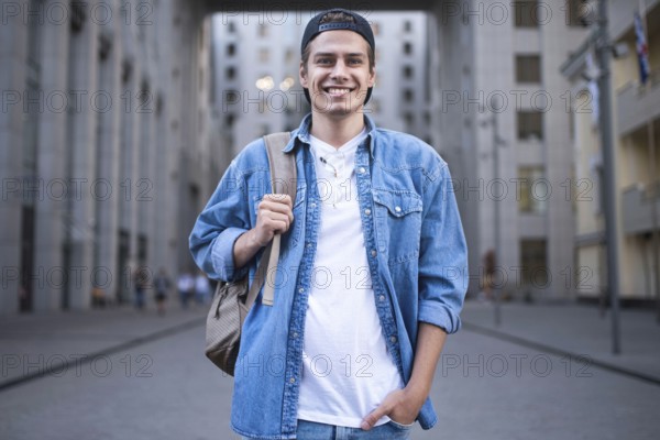 Background on the street while waiting his colleagues. Businessman wearing casual white shirt and spectacles. People