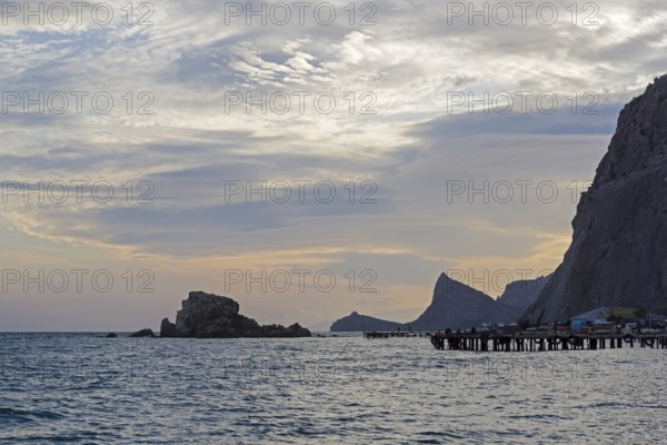 Sunset in the bay of the resort town of Sudak. Crimea