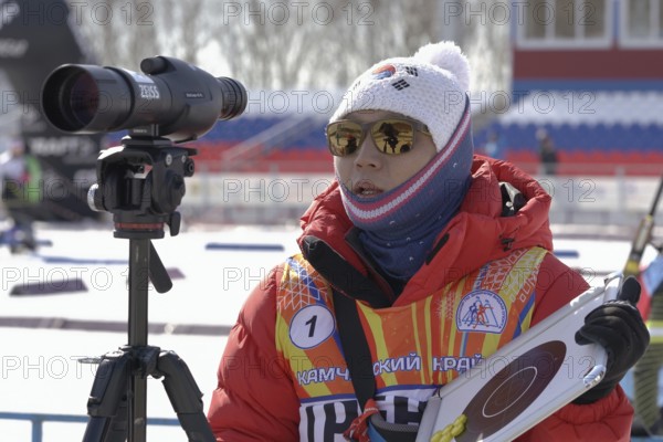 Coach of South Korea biathlon team instructs biathletes at shooting range of biathlon stadium during Junior biathlon competitions East of Cup. Kamchatka Peninsula, Russian Far East, April 14, 2019