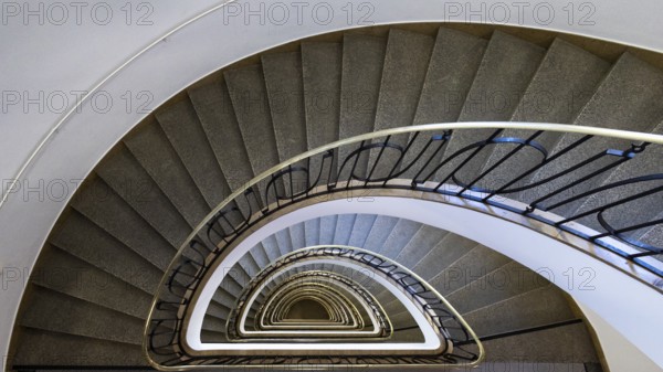 A spiral staircase with metal railings that displays impressive symmetry in the Altstadt-Lehe district, Munich, Bavaria, Germany, Europe