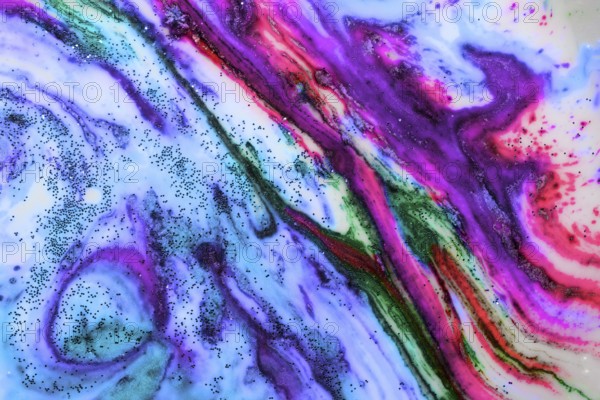 Multicoloured background of bright colours covered with gold sparkles