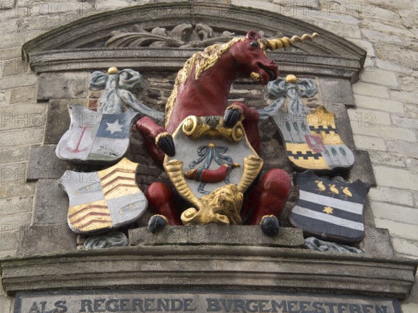 Stone relief with a red unicorn and several colourful coats of arms, hoorn, ijsselmeer, netherlands